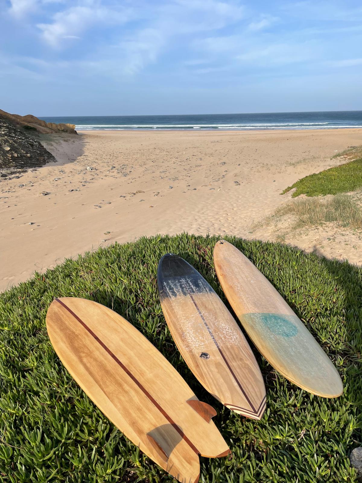 Surfboard on beach at sunset